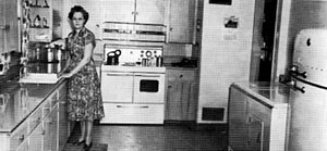 Electricity made life easier for everyone, including this woman and her family in a rural farmhouse in Phelps County. She stands in her kitchen with her new electric appliances. Source — Central Nebraska Public Power and Irrigation District.